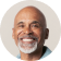 Smiling older man with a bald head and grey beard